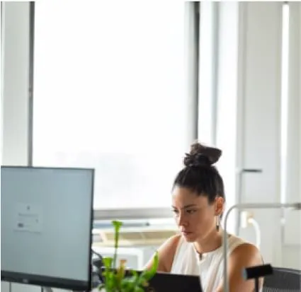 a girl in the office working on a laptop